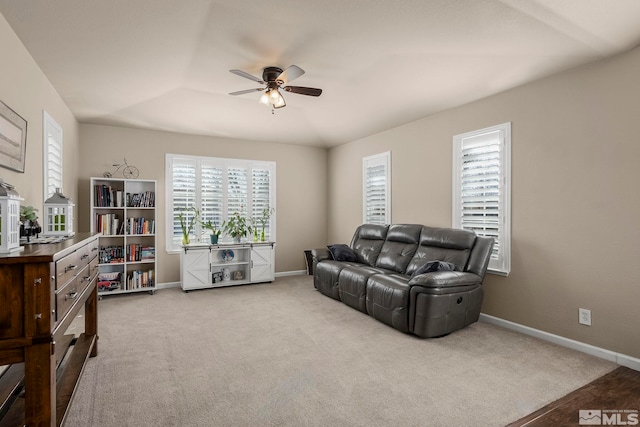 living room with plenty of natural light, ceiling fan, and light carpet