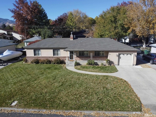 ranch-style house with covered porch, a front yard, and a garage