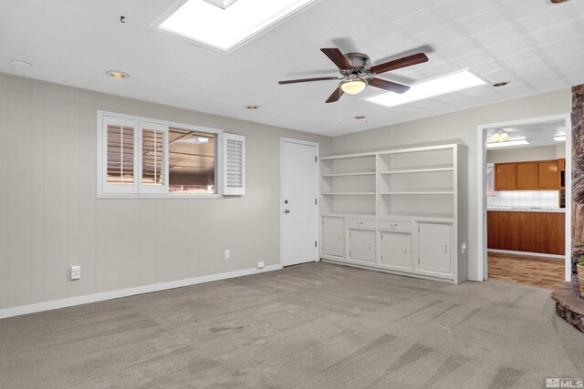 interior space featuring light carpet and ceiling fan