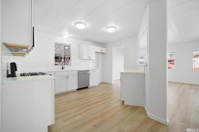 kitchen with white cabinetry, dishwasher, sink, light hardwood / wood-style flooring, and decorative backsplash