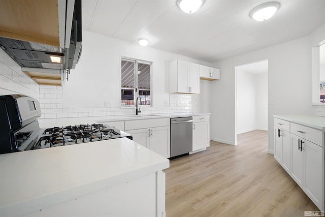 kitchen featuring white cabinetry, sink, stainless steel dishwasher, and stove