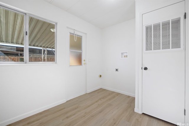 washroom with hookup for a washing machine, light hardwood / wood-style flooring, plenty of natural light, and electric dryer hookup