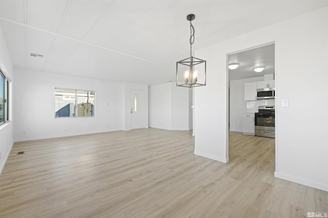 interior space featuring light hardwood / wood-style floors and an inviting chandelier