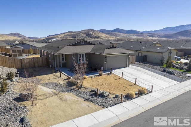 ranch-style house with a mountain view and a garage