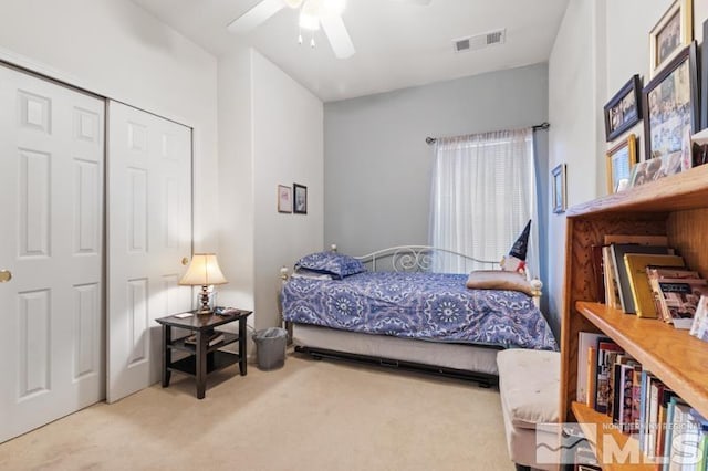 carpeted bedroom with a closet and ceiling fan