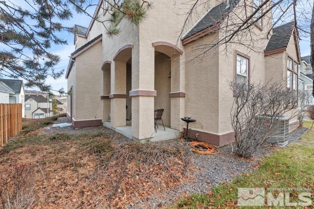 view of side of home featuring central AC