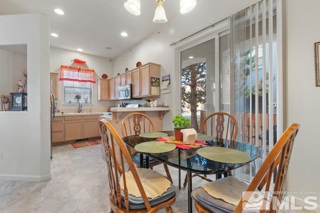 dining room with a notable chandelier and sink