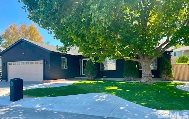 view of front of property with a garage and a front lawn