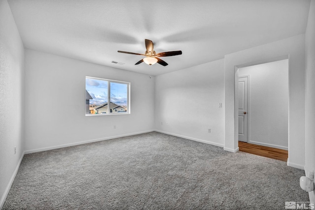 carpeted empty room with ceiling fan