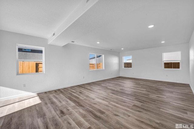 unfurnished living room with hardwood / wood-style flooring