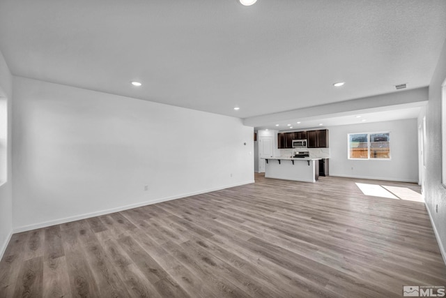 unfurnished living room featuring light wood-type flooring