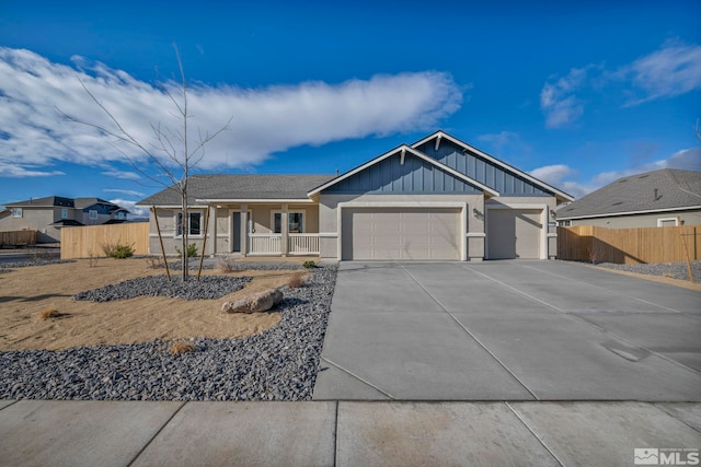 view of front of property with a porch and a garage