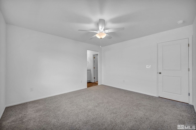 carpeted spare room featuring ceiling fan