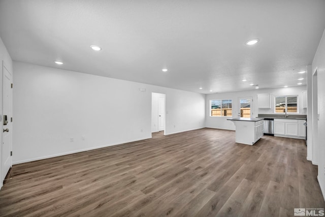 unfurnished living room with a textured ceiling and hardwood / wood-style flooring