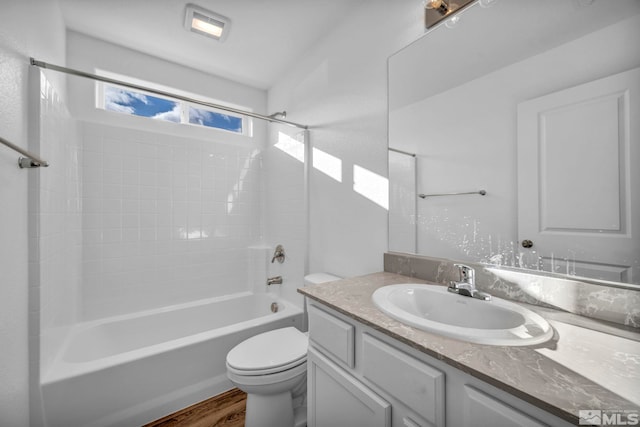 full bathroom featuring shower / tub combination, vanity, toilet, and hardwood / wood-style floors