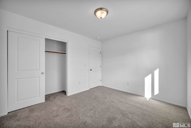 unfurnished bedroom with carpet floors and a closet