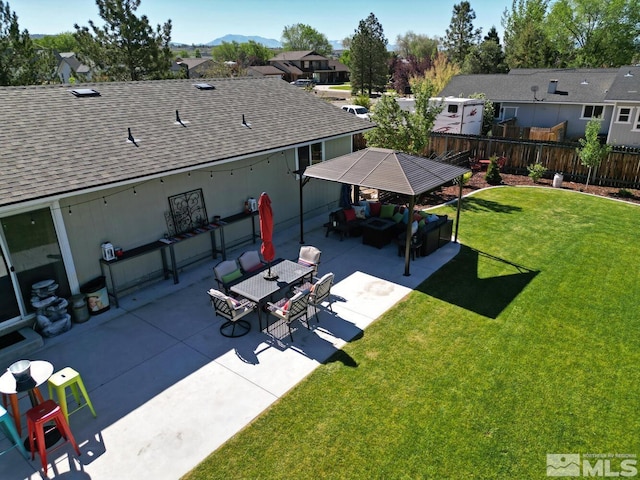 exterior space featuring outdoor lounge area, a mountain view, and a patio area