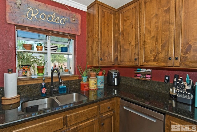 kitchen with dishwasher, dark stone countertops, ornamental molding, and sink