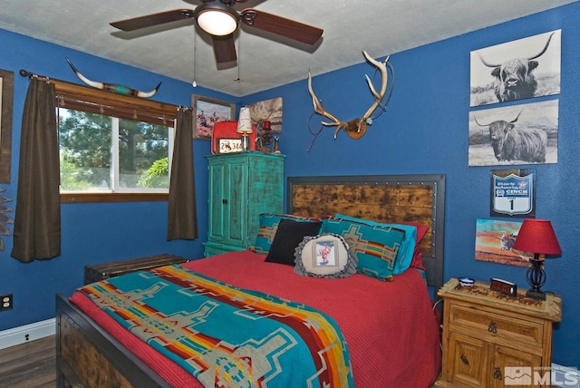 bedroom featuring hardwood / wood-style flooring, ceiling fan, and a textured ceiling