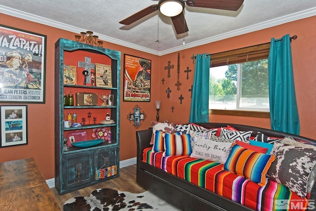 bedroom with ceiling fan, crown molding, dark hardwood / wood-style floors, and a textured ceiling