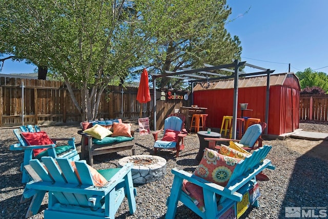 view of patio / terrace featuring a fire pit and a storage unit