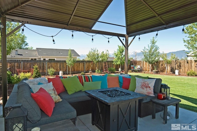 view of patio / terrace featuring a gazebo and an outdoor living space with a fire pit