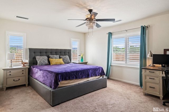 bedroom with multiple windows, light carpet, and ceiling fan