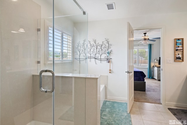 bathroom with tile patterned floors, ceiling fan, and plus walk in shower