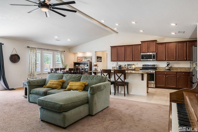 living room with light carpet, ceiling fan, and lofted ceiling