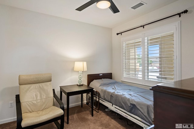 bedroom with ceiling fan and dark carpet