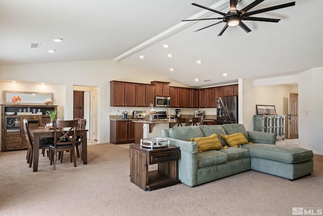 carpeted living room with vaulted ceiling with beams and ceiling fan