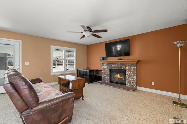 living room featuring carpet, ceiling fan, and a brick fireplace