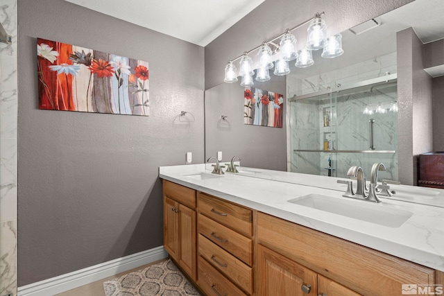 bathroom featuring vanity and a shower with door