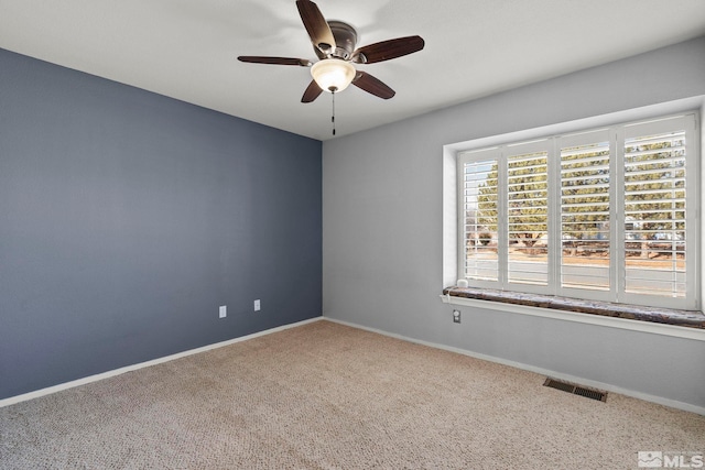 spare room featuring ceiling fan and carpet floors