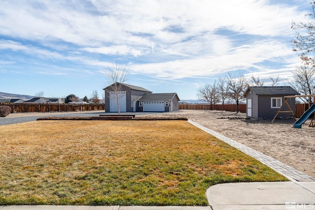 view of yard with a playground, a shed, and a garage