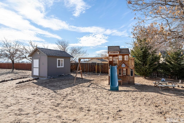 view of yard featuring a playground and a storage unit