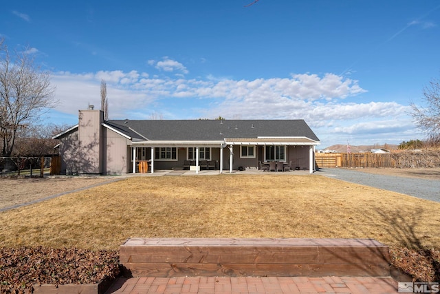 view of front of property with a patio area and a front yard