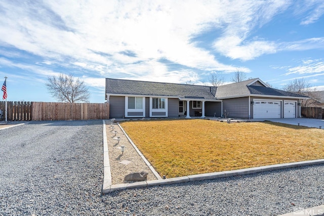 ranch-style house with a garage and a front lawn