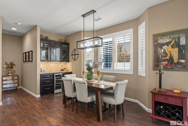 dining room with bar, wine cooler, and dark wood-type flooring