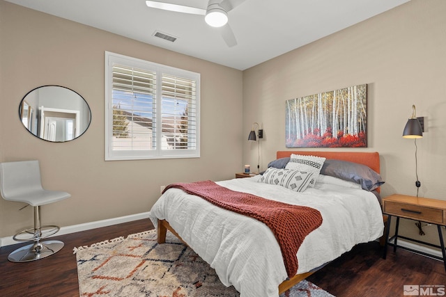 bedroom with dark hardwood / wood-style floors and ceiling fan