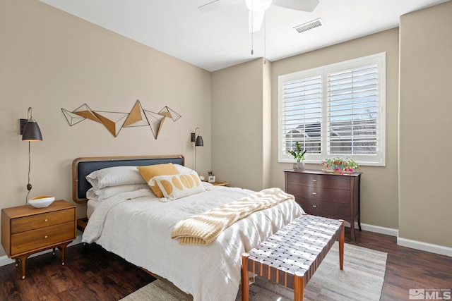 bedroom with dark hardwood / wood-style flooring and ceiling fan