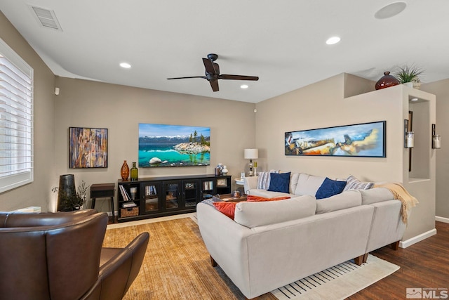 living room with hardwood / wood-style floors, plenty of natural light, and ceiling fan