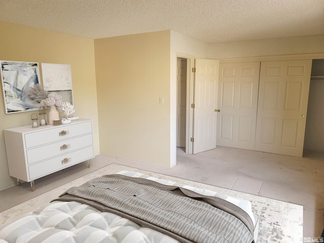 bedroom with a textured ceiling and a closet