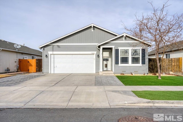 view of front of property featuring a front lawn and a garage