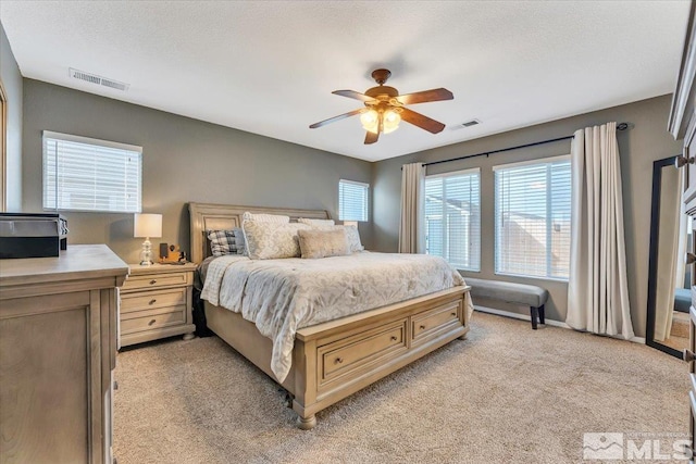 bedroom featuring ceiling fan and light colored carpet