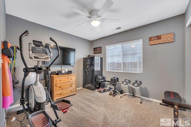 workout area featuring carpet and ceiling fan