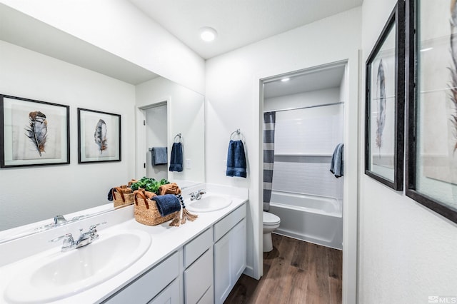 full bathroom featuring hardwood / wood-style flooring, vanity, toilet, and shower / bath combo