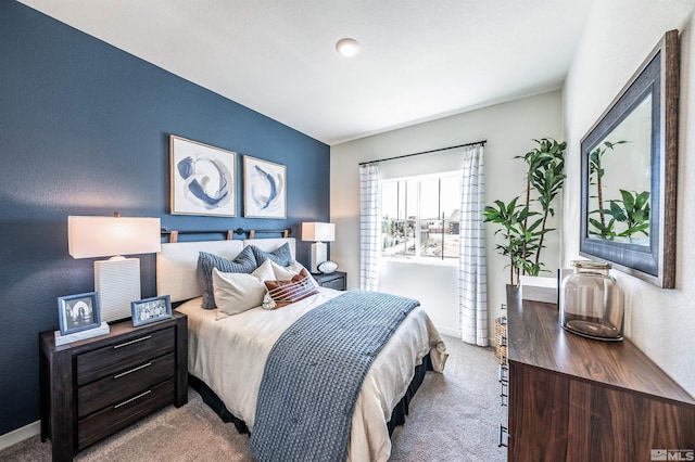 bedroom featuring light colored carpet