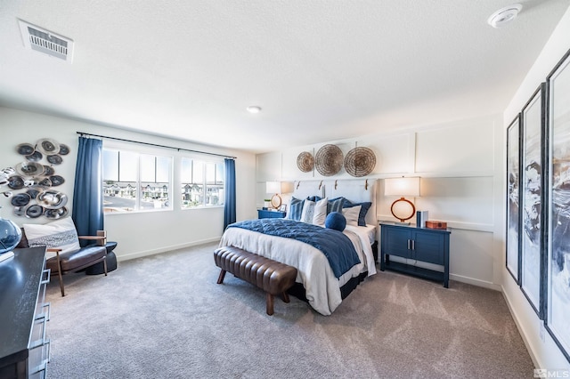 bedroom featuring a textured ceiling and carpet floors