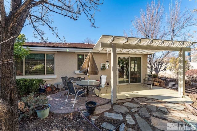 back of house with a pergola and a patio area